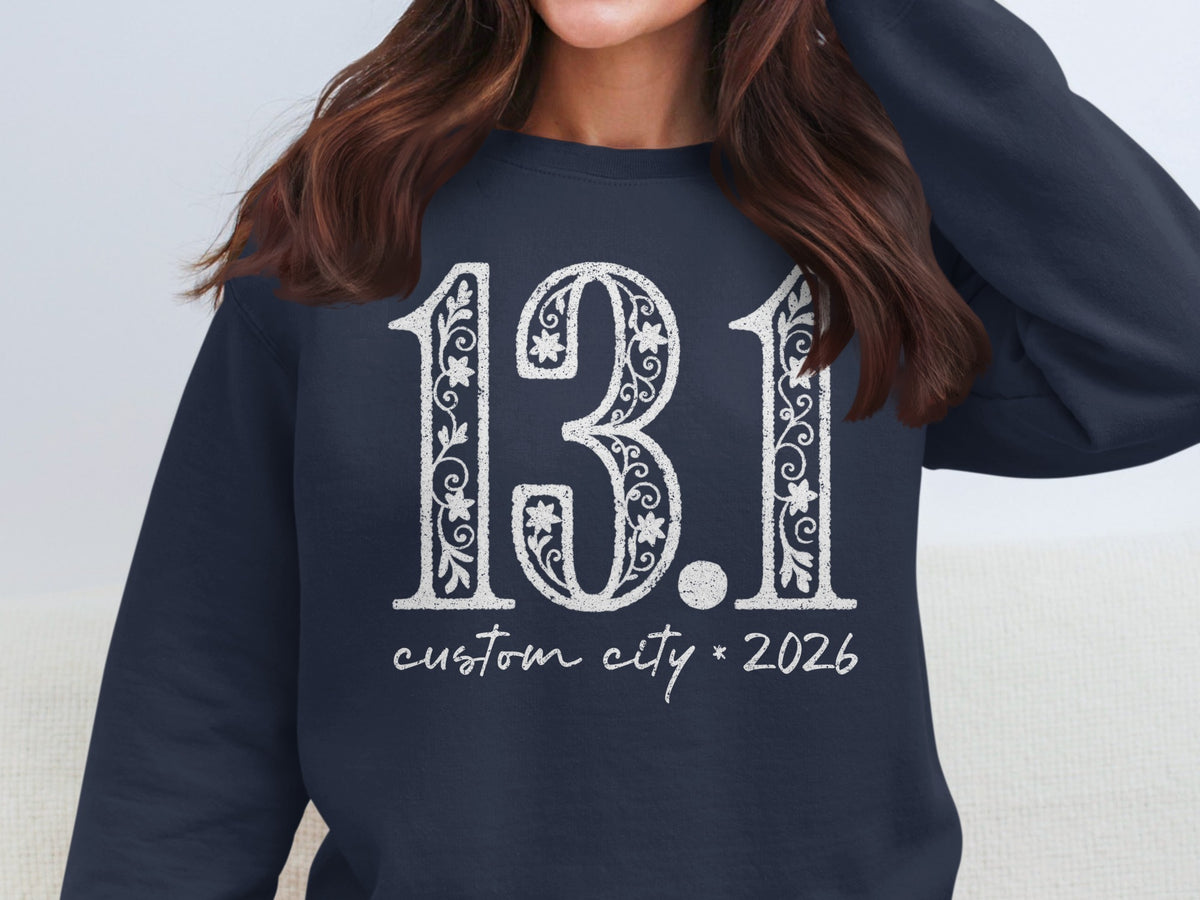 Dark navy sweatshirt with white "13.1 custom city * 2026" text.