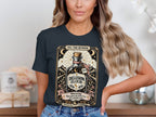 T-shirt graphic with "Delusion Elixir" bottle, stars, moon, mountains, and warning text.