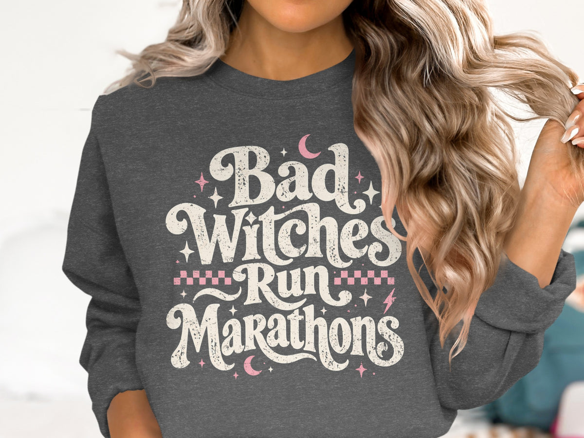Dark gray sweatshirt with "Bad Witches Run Marathons" text and pink accents.