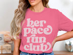 Pink t-shirt with white text "her pace run club"