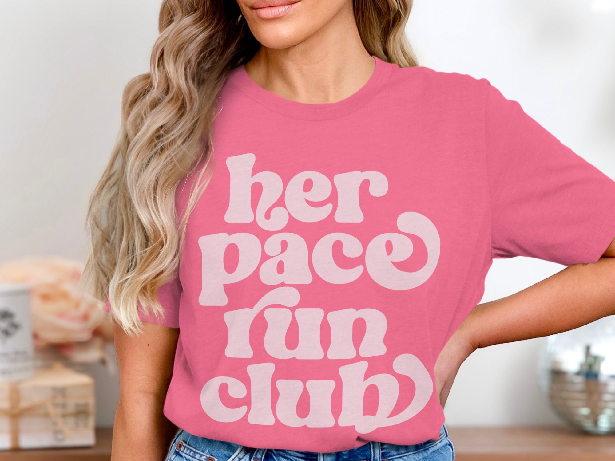 Pink t-shirt with white text "her pace run club"