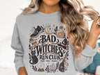 Graphic on gray sweatshirt: "Bad Witches Run Club" with witch hat, cat, and broom.