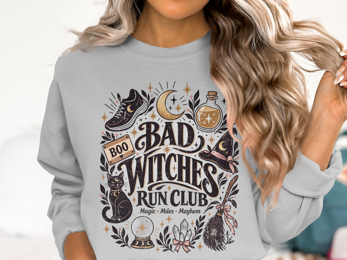 Graphic on gray sweatshirt: "Bad Witches Run Club" with witch hat, cat, and broom.