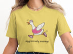Yellow t-shirt with a running goose illustration and text "aggressively average".