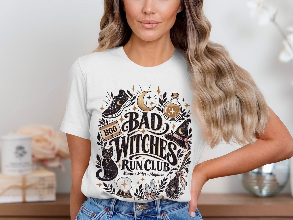 White t-shirt with "Bad Witches Run Club Magic Miles Mayhem" graphic.