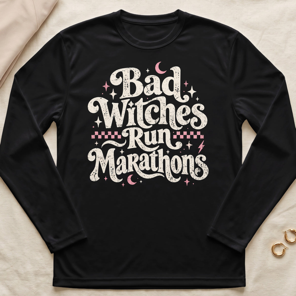 Black long sleeve shirt with distressed text "Bad Witches Run Marathons."