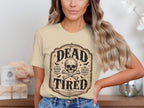 T-shirt graphic with skull, bones, bats, and text "DEAD TIRED"