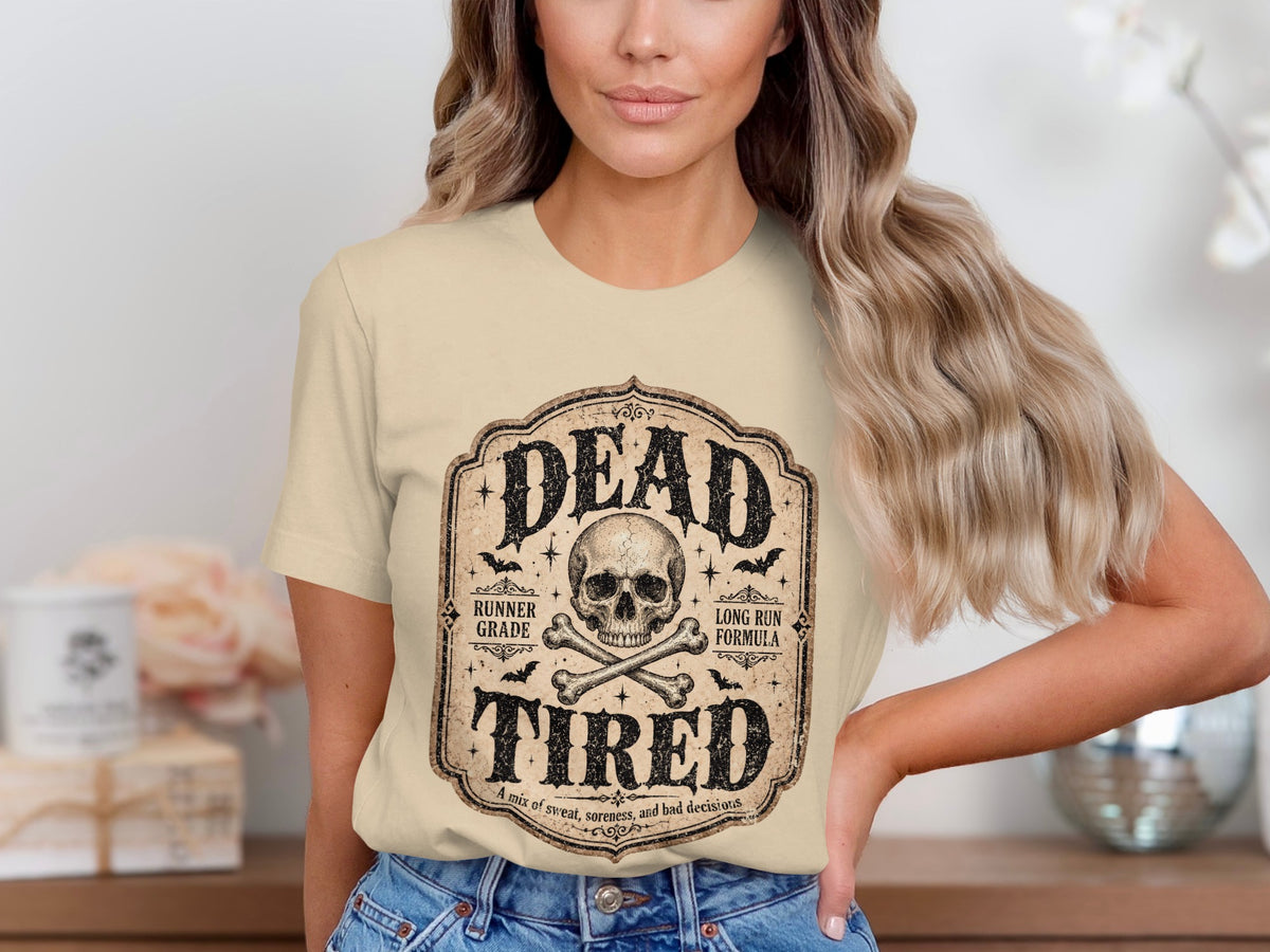 T-shirt graphic with skull, bones, bats, and text "DEAD TIRED"