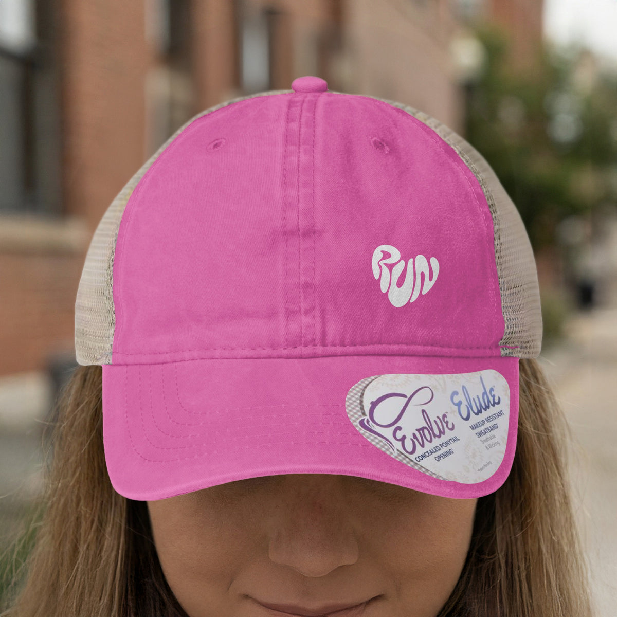 Pink trucker hat with "Run" in a heart on the front and a product tag.