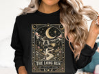 Black sweatshirt with "The Long Run" graphic featuring a runner under the moon.