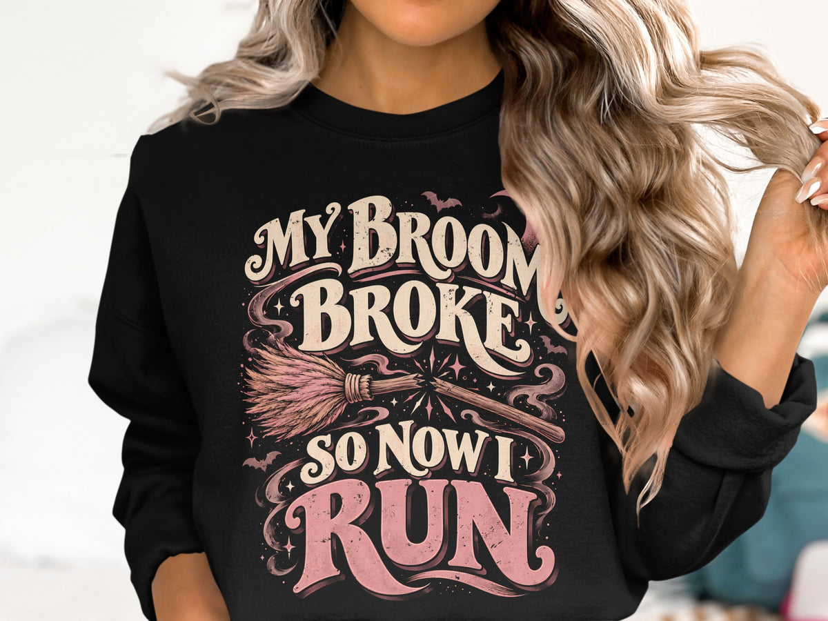 Black sweatshirt with "My Broom Broke So Now I Run" Halloween graphic.