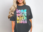 Dark grey t-shirt with tie-dye text reading "long miles high vibes".