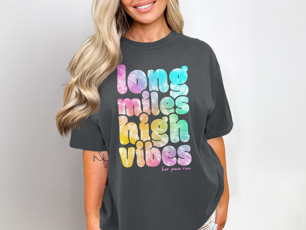Dark grey t-shirt with tie-dye text reading "long miles high vibes".