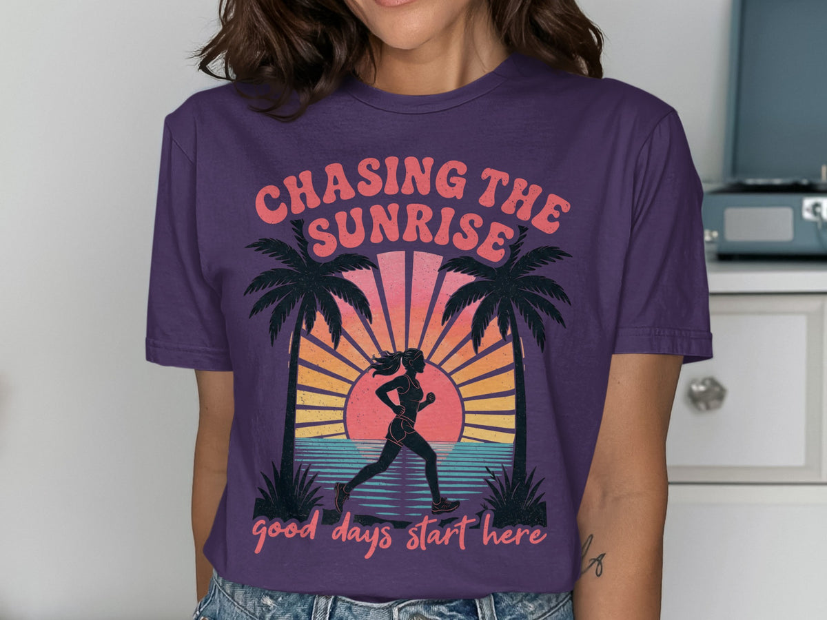 Purple t-shirt with "Chasing The Sunrise" and a runner by palm trees.