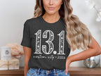 Dark grey t-shirt with "13.1 custom city * 2026" in white distressed lettering.