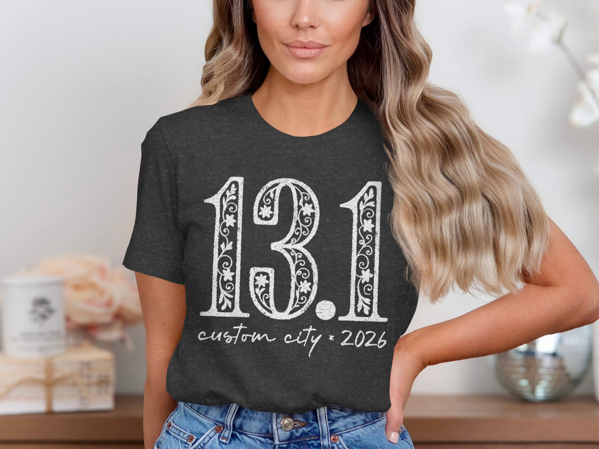 Dark grey t-shirt with "13.1 custom city * 2026" in white distressed lettering.
