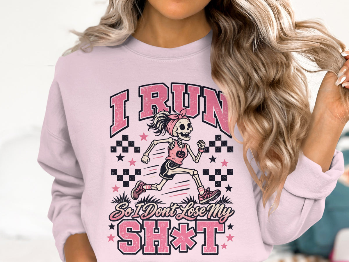 Pink crewneck sweatshirt with a skeleton runner graphic and text.