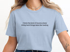 Light blue t-shirt with black text: "i have the kind of trauma where doing hard things feels like healing"