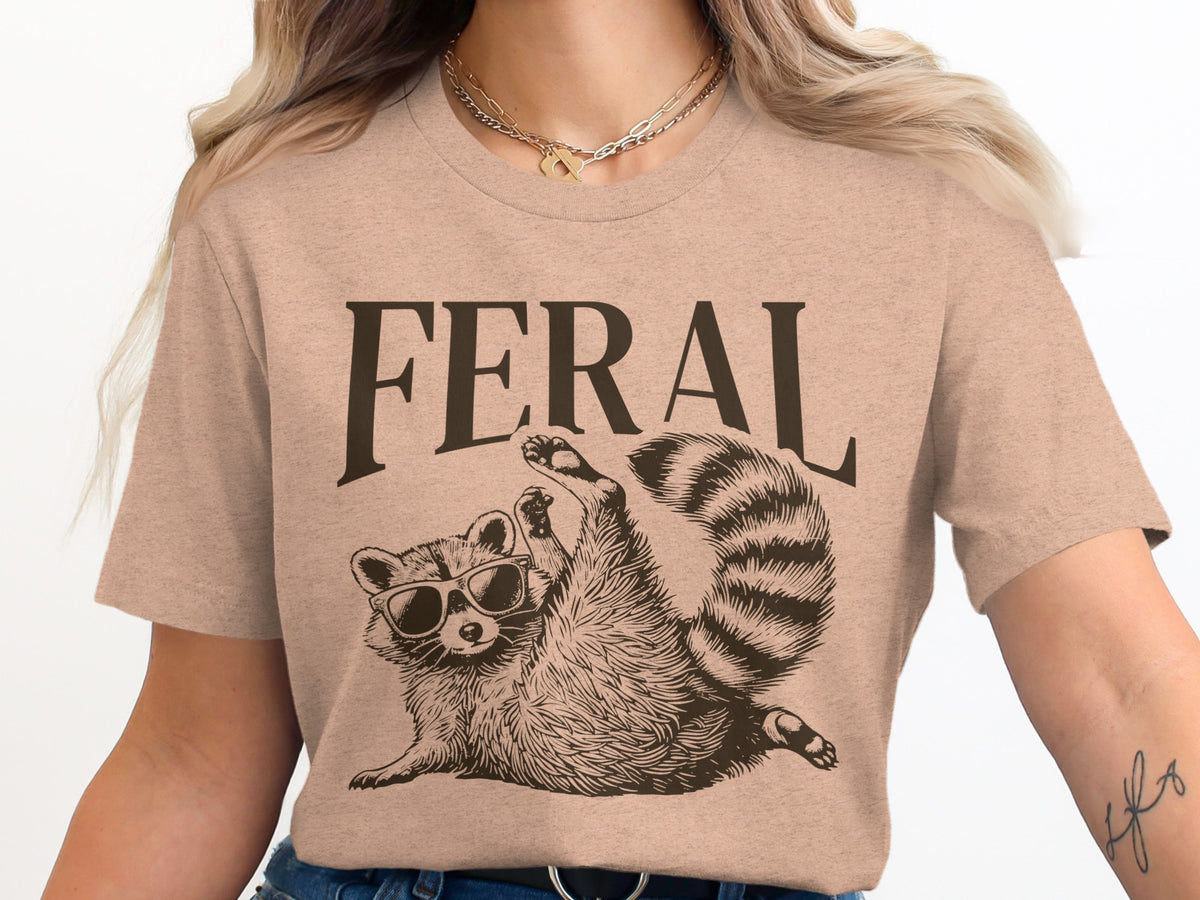T-shirt with "FERAL" text and a drawing of a raccoon wearing sunglasses.