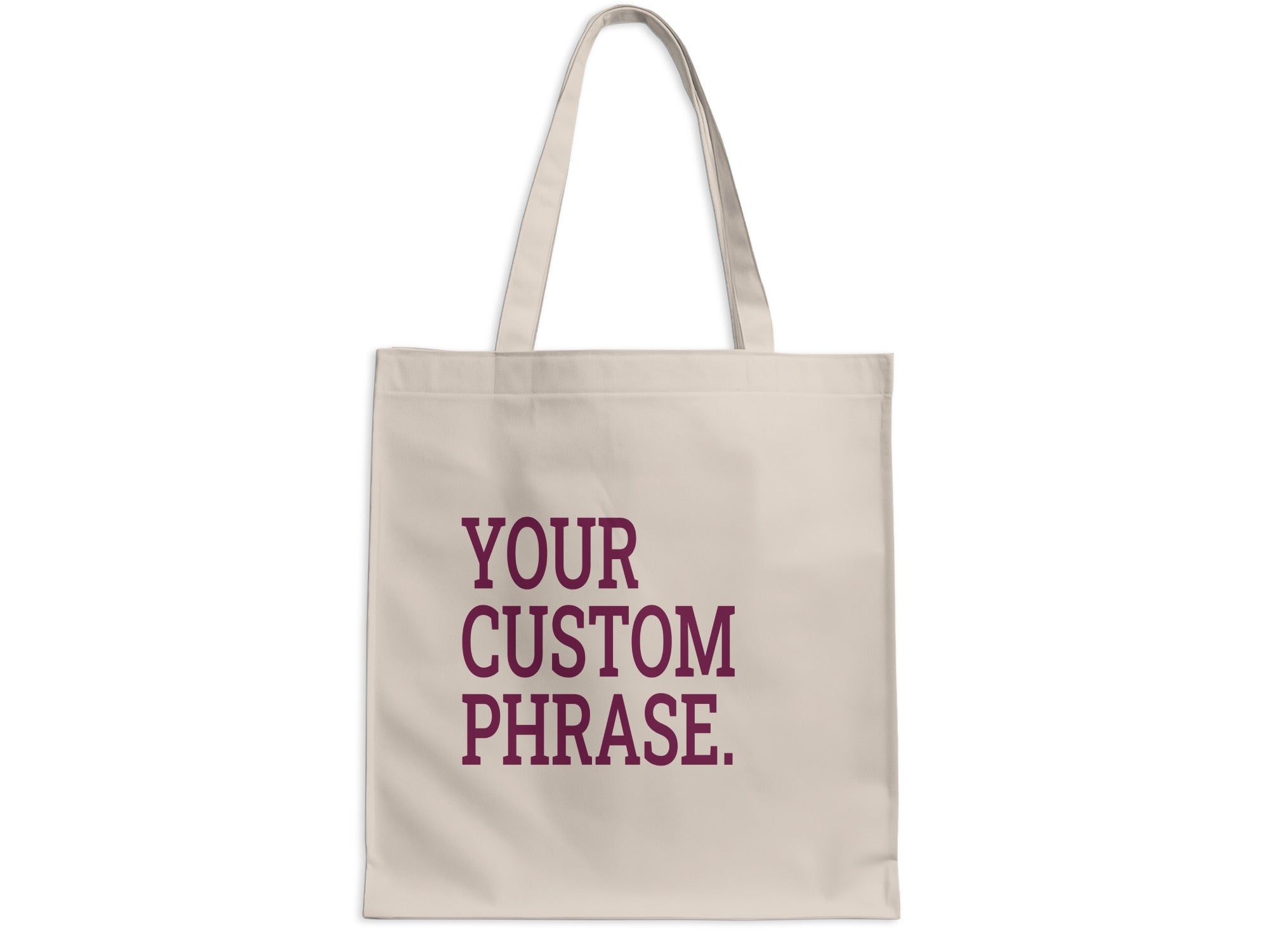 Beige tote bag with "YOUR CUSTOM PHRASE." text in maroon.