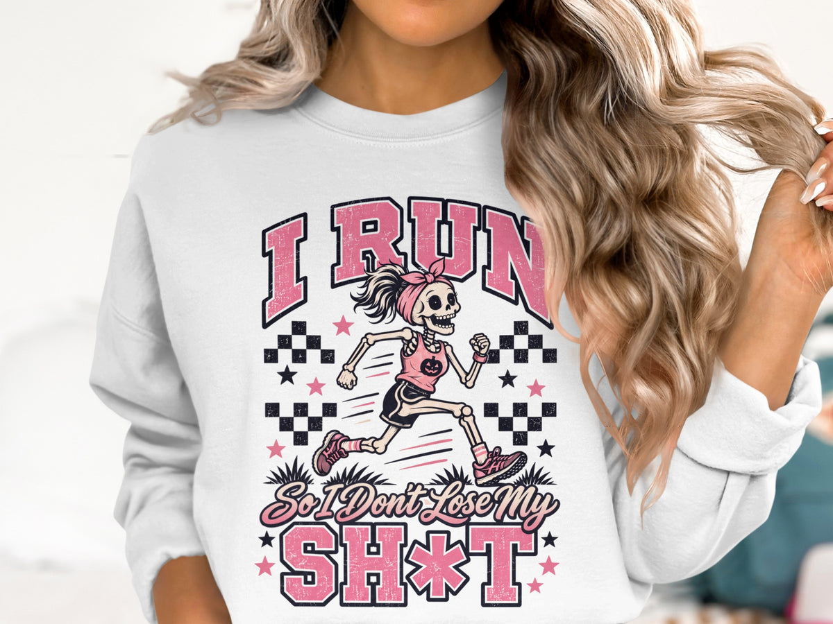 White sweatshirt with a running skeleton graphic and text "I RUN So I Don't Lose My SH*T".