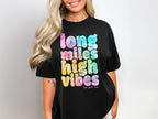 Black t-shirt with "long miles high vibes" in tie-dye lettering.