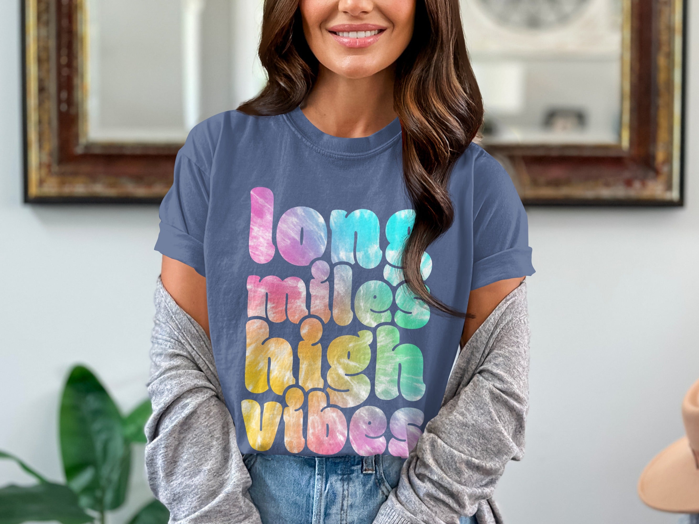 Blue t-shirt with "long miles high vibes" text in colorful tie-dye pattern.