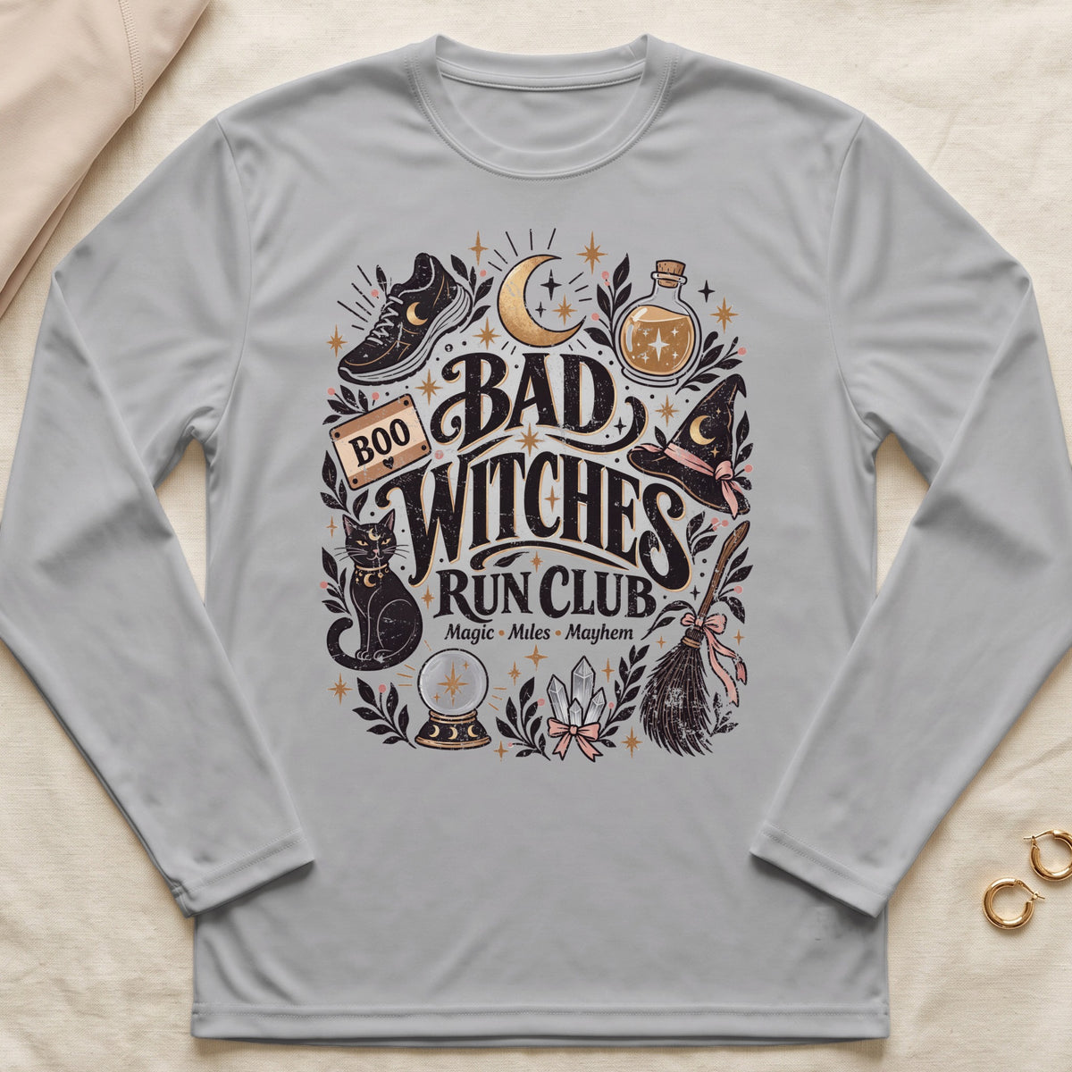 Gray long-sleeve shirt with "Bad Witches Run Club" graphic featuring a cat, cauldron, and crystals.