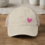 Cream trucker hat with pink "RUN" heart graphic on front.