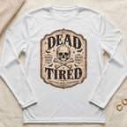 White long sleeve shirt with "DEAD TIRED" graphic, skull, bones, bats, and text.