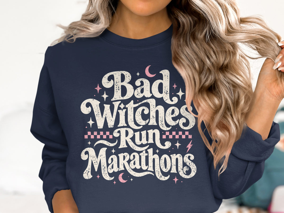 Navy sweatshirt with distressed text "Bad Witches Run Marathons" and celestial accents.