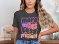 Dark gray t-shirt with "more miles less pressure her pace run" text gradient.
