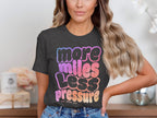 Dark gray t-shirt with "more miles less pressure her pace run" text gradient.