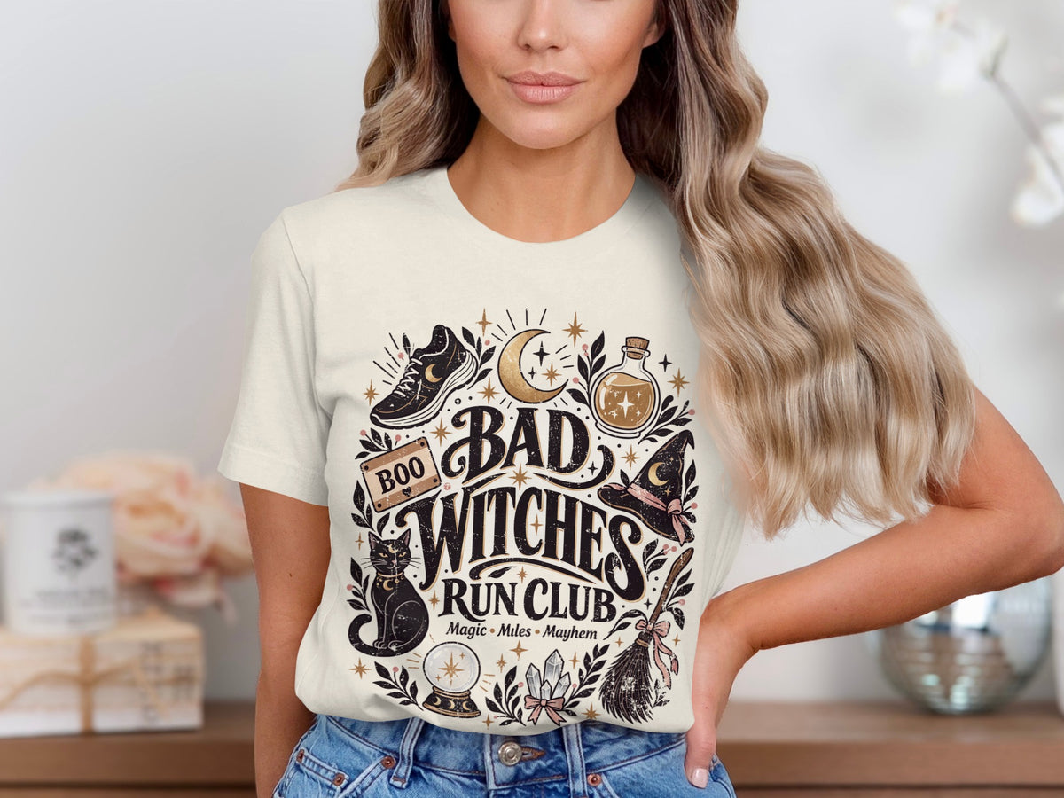 Graphic tee with "Bad Witches Run Club" text and witchy icons.