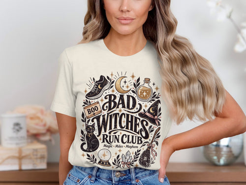 Graphic tee with "Bad Witches Run Club" text and witchy icons.