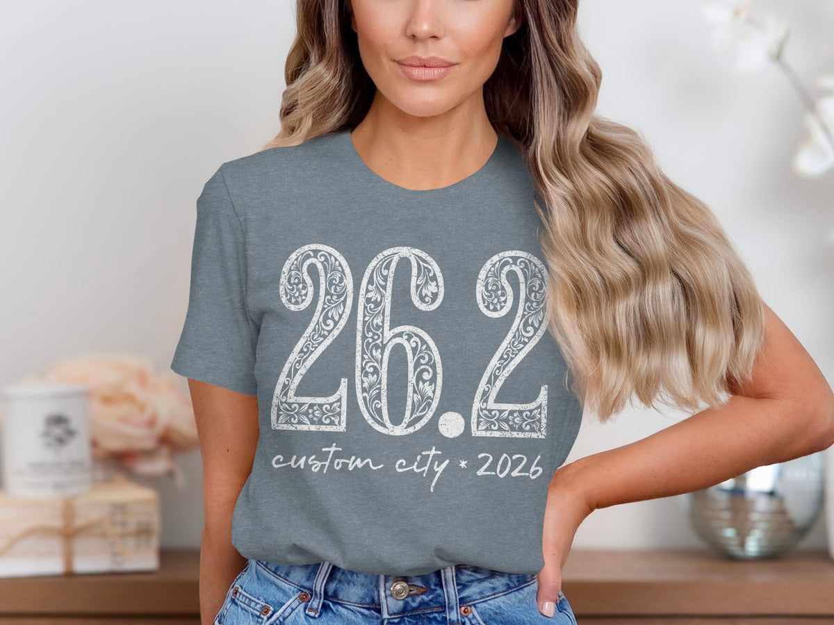 Gray t-shirt with white "26.2 custom city * 2026" text and floral design.