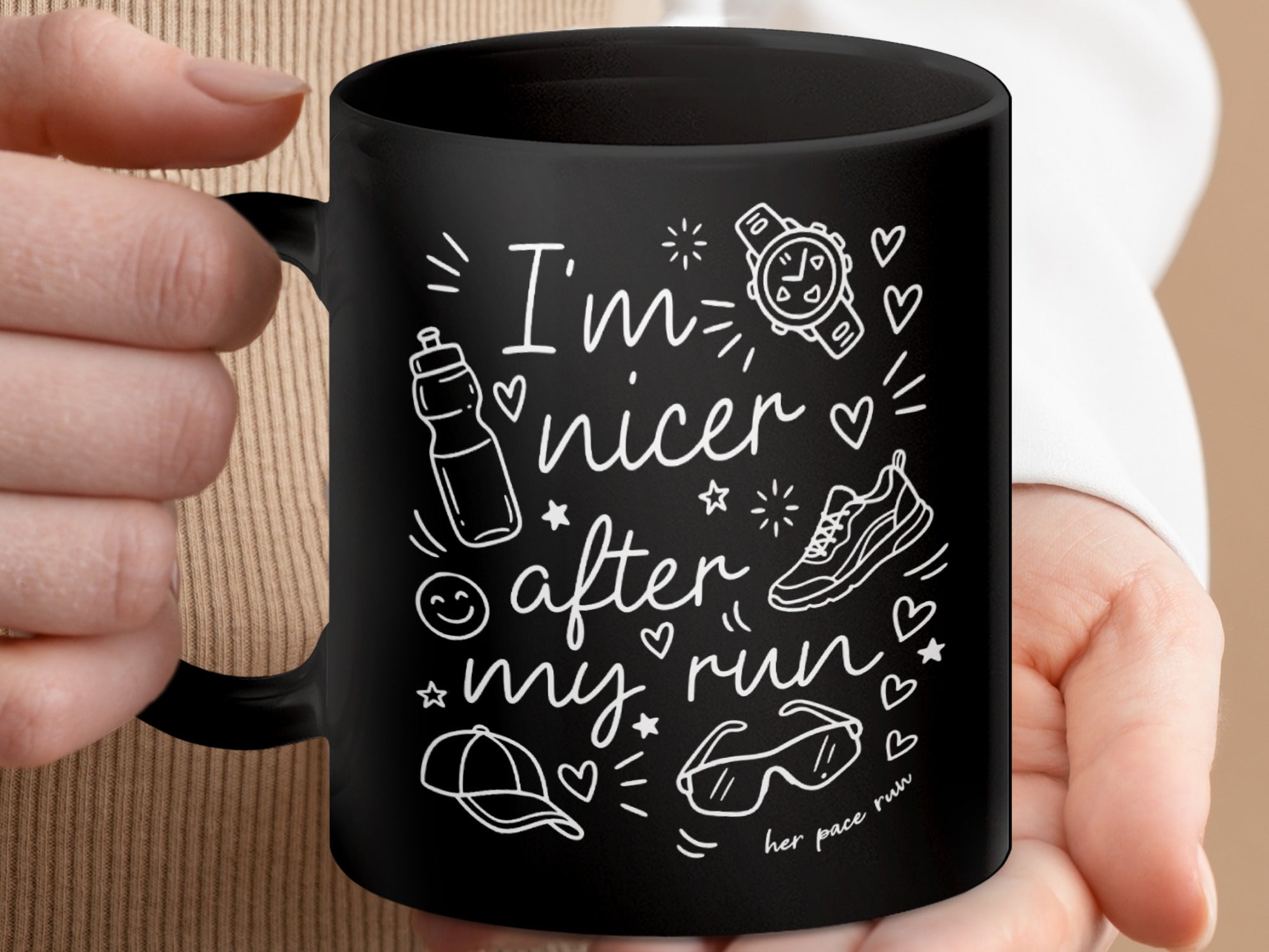Black mug with white running-themed doodles and "I'm nicer after my run" text.