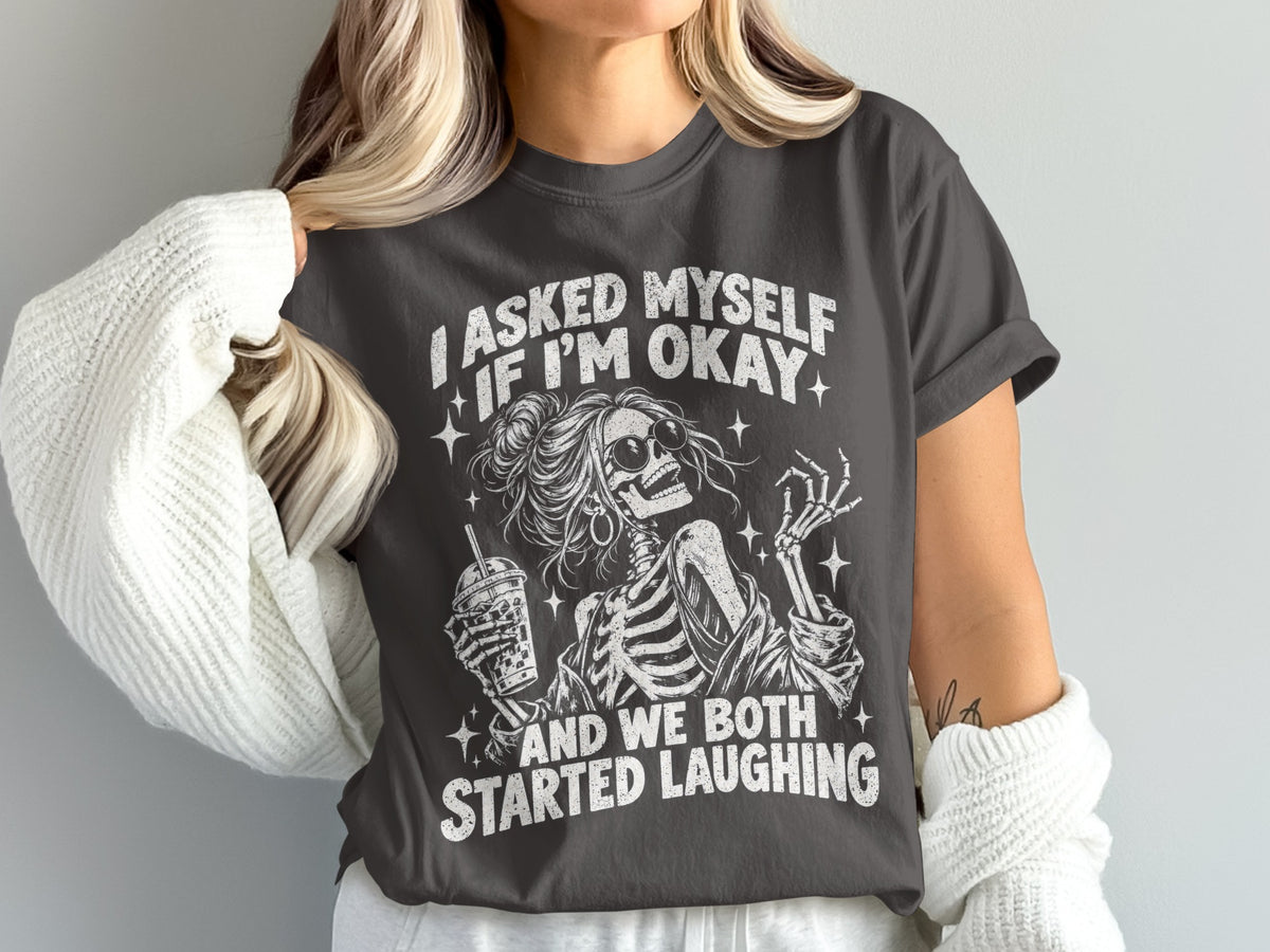 Dark gray t-shirt with skeleton graphic and text "I asked myself if I'm okay and we both started laughing."