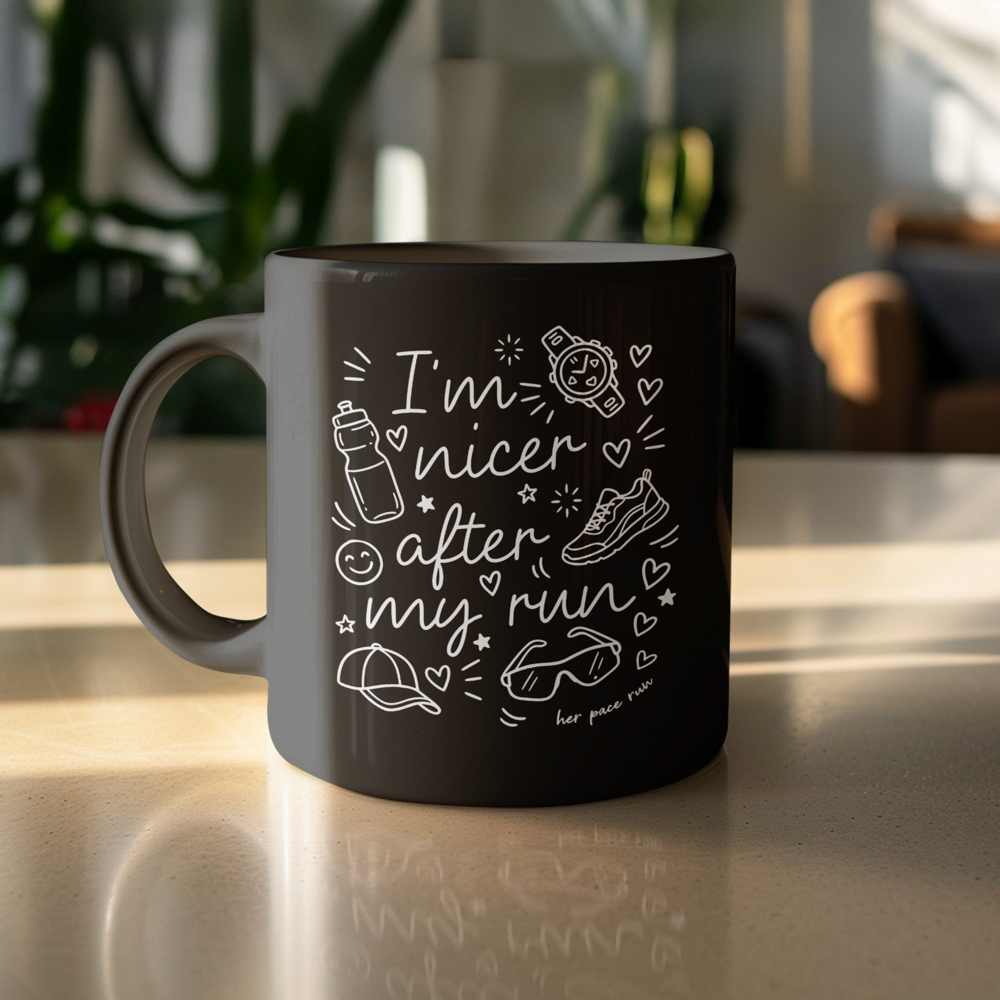 Black mug with white text and drawings: "I'm nicer after my run."