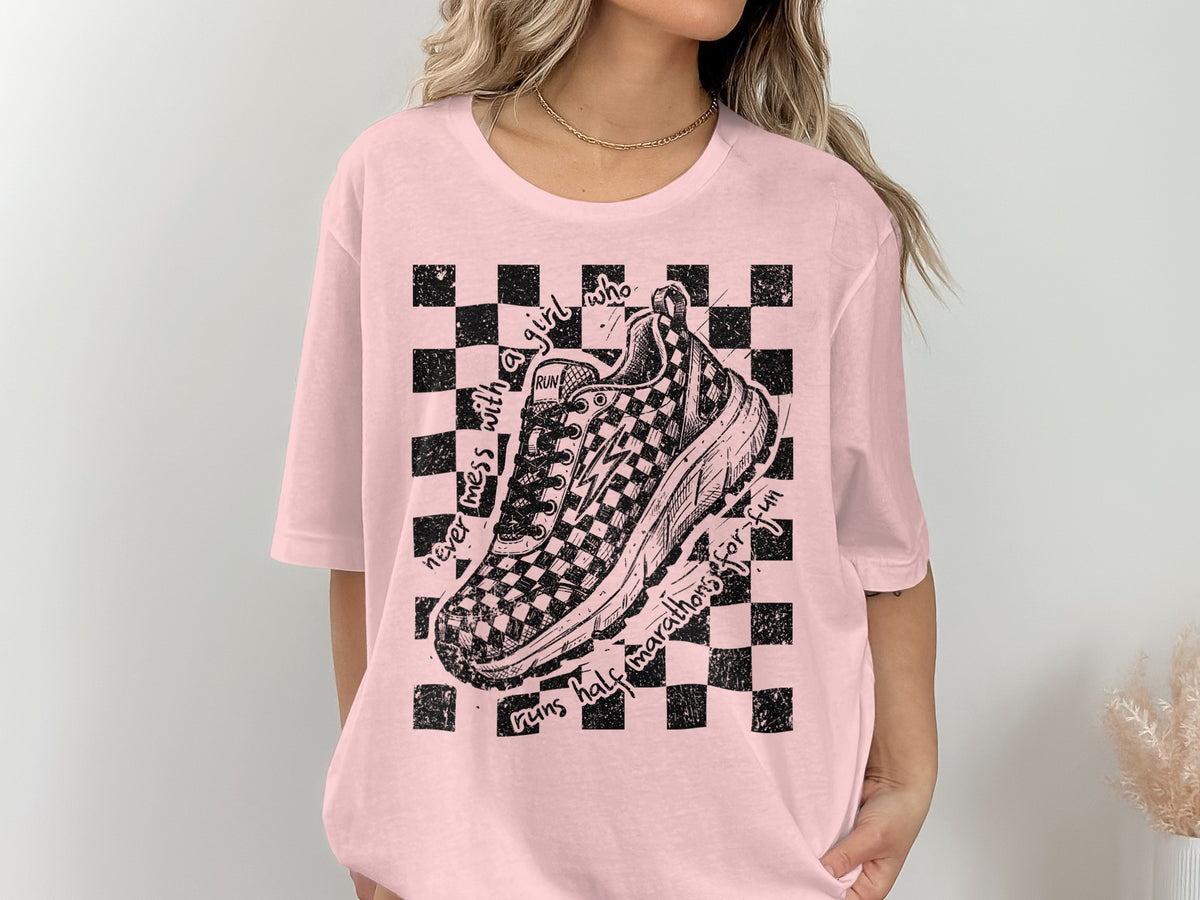 Pink t-shirt with checkered pattern and sketch of a running shoe.
