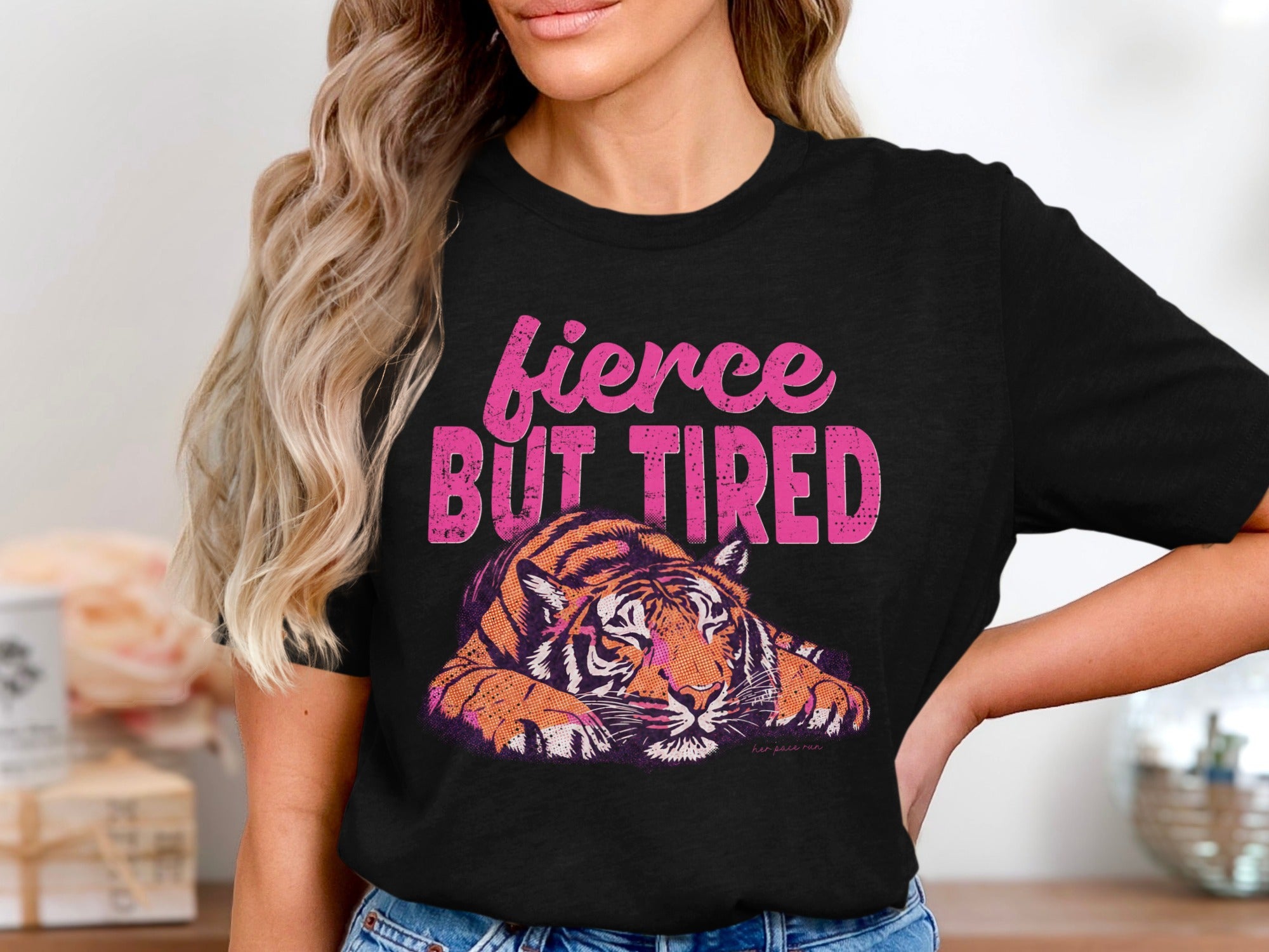 Black t-shirt with a tiger graphic and text that reads "fierce but tired."