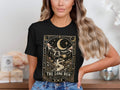 Black t-shirt graphic with a runner on a path under a crescent moon, text "The Long Run".