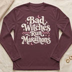 Maroon long-sleeve shirt with "Bad Witches Run Marathons" graphic and celestial accents.