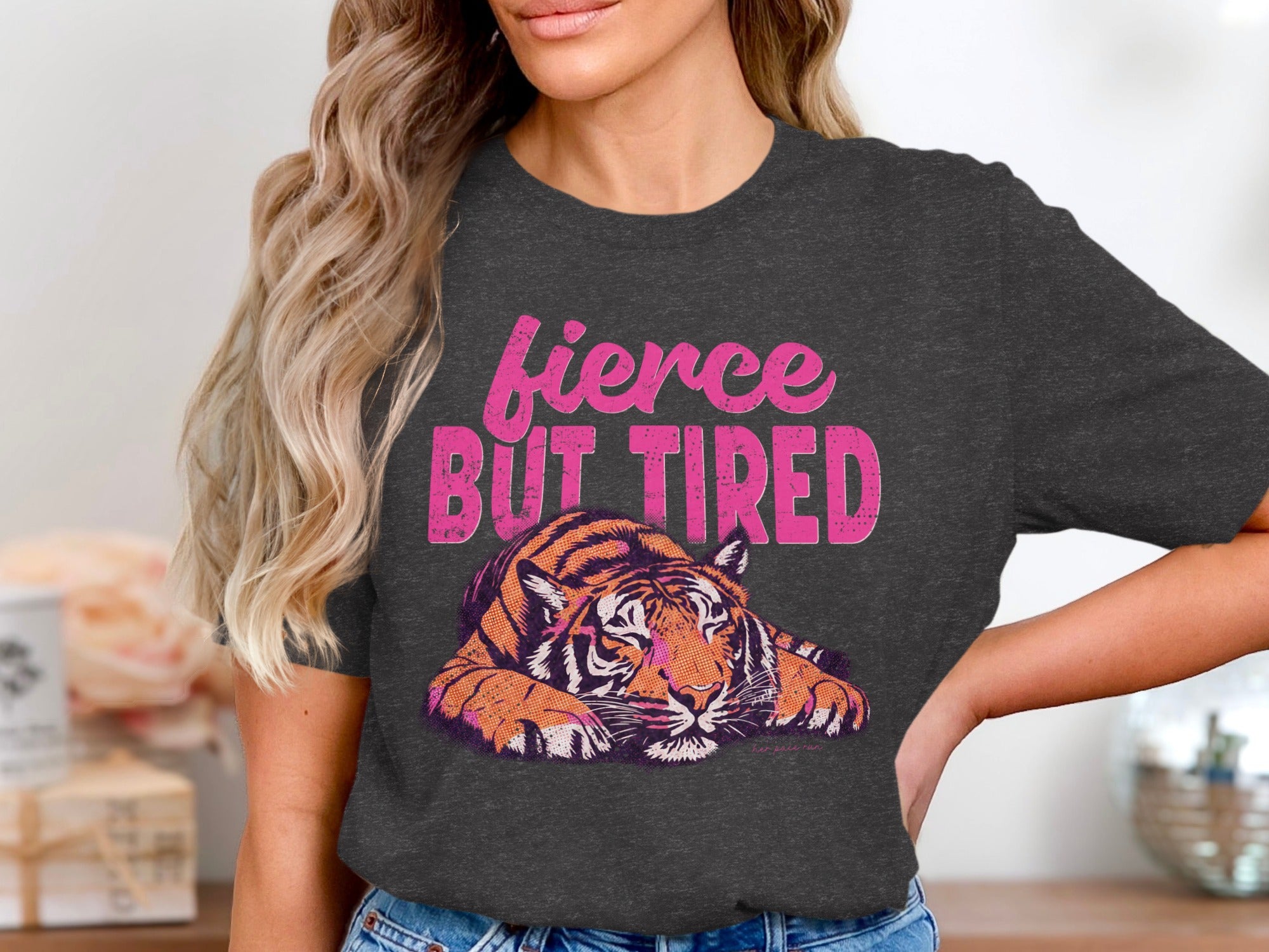 Charcoal t-shirt with "fierce BUT TIRED" text and a lounging tiger graphic.