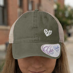 Green trucker hat with white "run" heart logo and a white tag.
