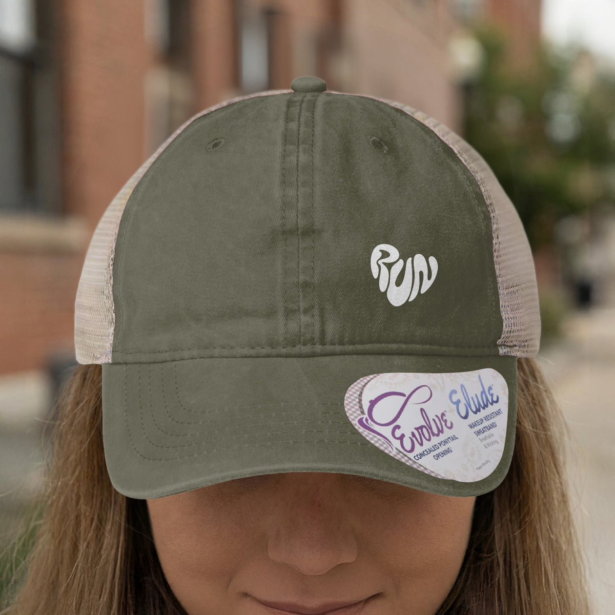 Green trucker hat with white "run" heart logo and a white tag.