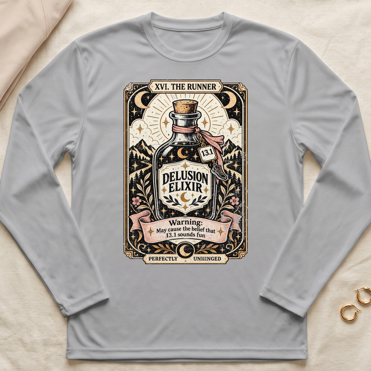 Grey long-sleeve shirt with "Delusion Elixir" and runner-themed graphic.