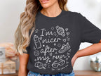 Dark gray t-shirt with white text "I'm nicer after my run" and running graphics.