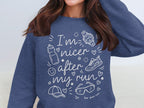 Navy sweatshirt with white text "I'm nicer after my run" and running icons.