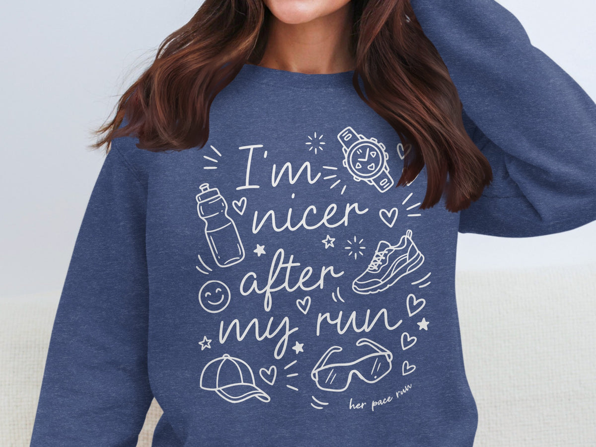 Navy sweatshirt with white text "I'm nicer after my run" and running icons.
